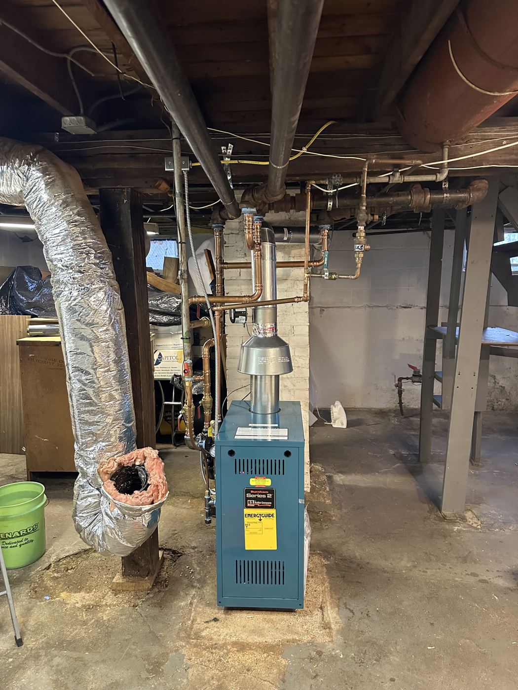 Boiler in an unfinished basement serviced by Anderson Burner
